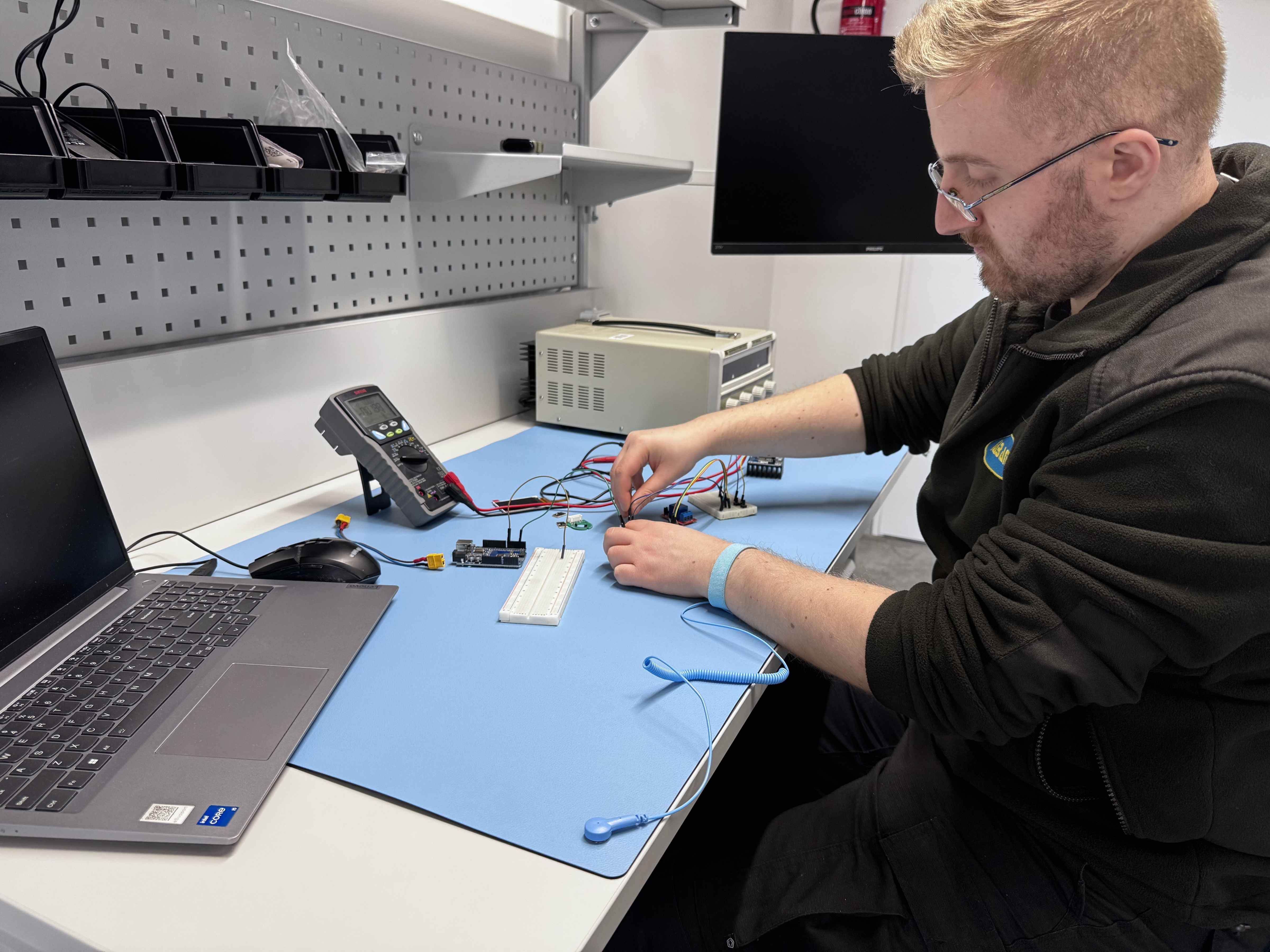 ESD mat with connected wrist strap snap
